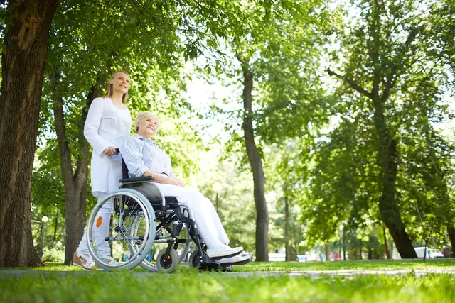 Home Caregiver Nurse Walking With Senior Patient 640