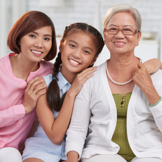 Home health care in overland park. Happy hugging Asian family of three