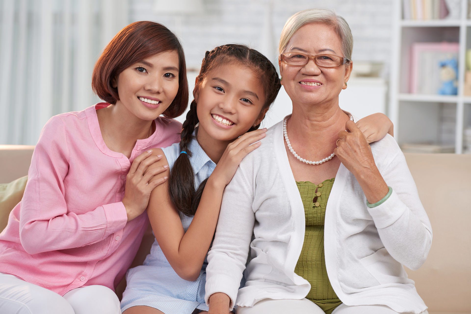 Home health care in overland park. Happy hugging Asian family of three